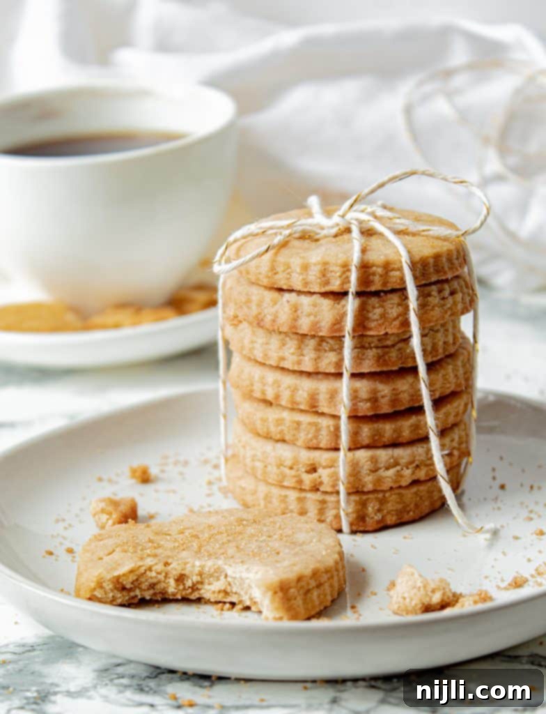 Golden Brown Shortbread Perfection 5 stack of brown sugar shortbread cookies tied with string, with a cup of coffee in the background