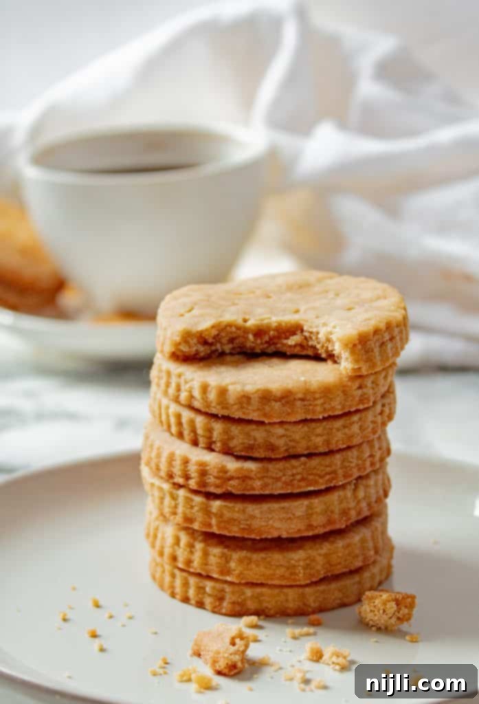 Golden Brown Shortbread Perfection 9 stack of brown sugar shortbread cookies with a cup of coffee in the background