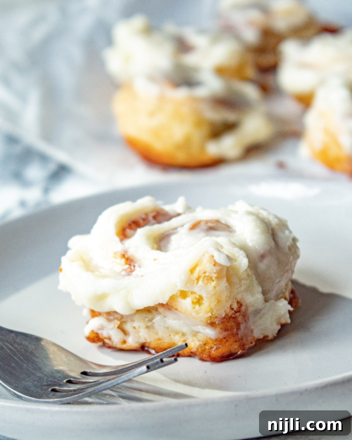 Flaky Cinnamon Rolls 4 Puff pastry cinnamon rolls on a plate with a fork
