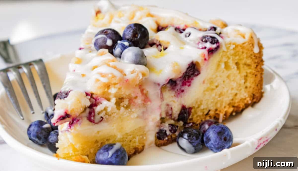 Blueberry Lemon Cream cheese Coffee Cake on a plate with a fork