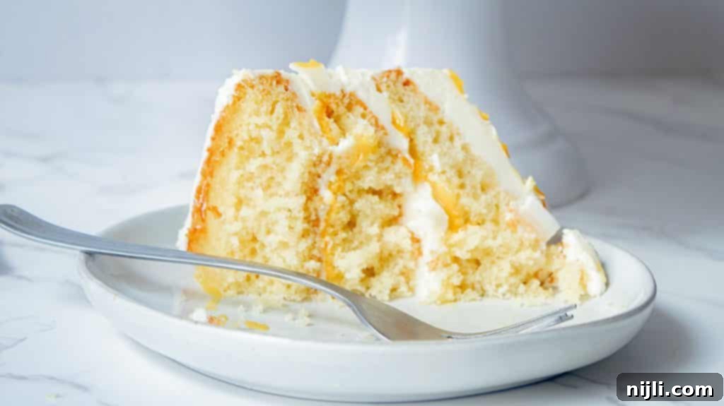 Passionfruit White Chocolate Dream Cake 3 Slice of White Chocolate and Passionfruit Cake on a plate