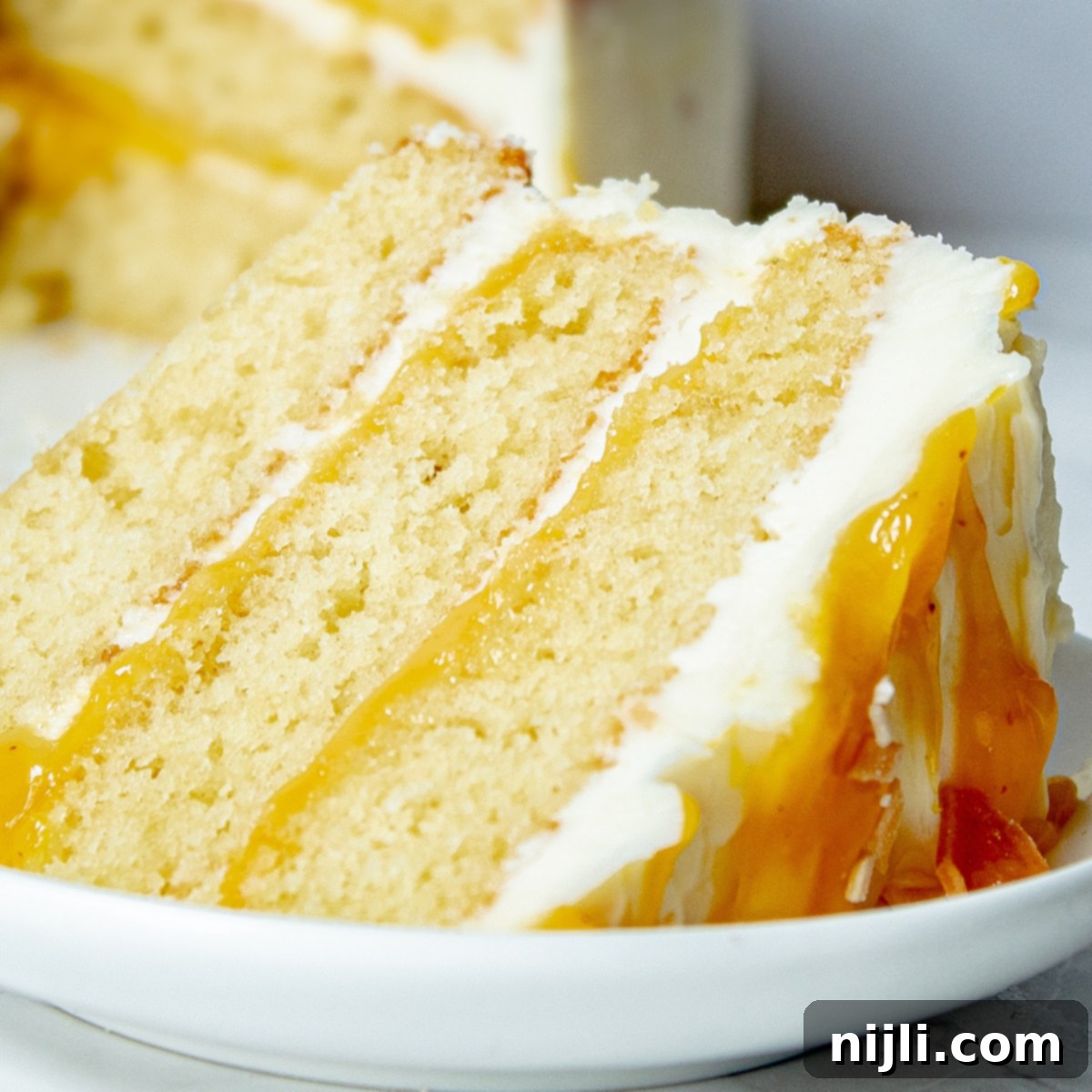 Passionfruit White Chocolate Dream Cake 8 Closeup of vanilla passionfruit cake slice