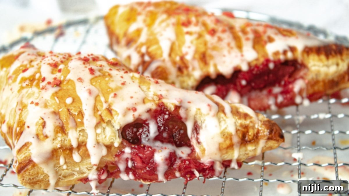 Sweet Strawberry Hand Pies 6 Baked and uniced strawberry turnovers on a baking tray