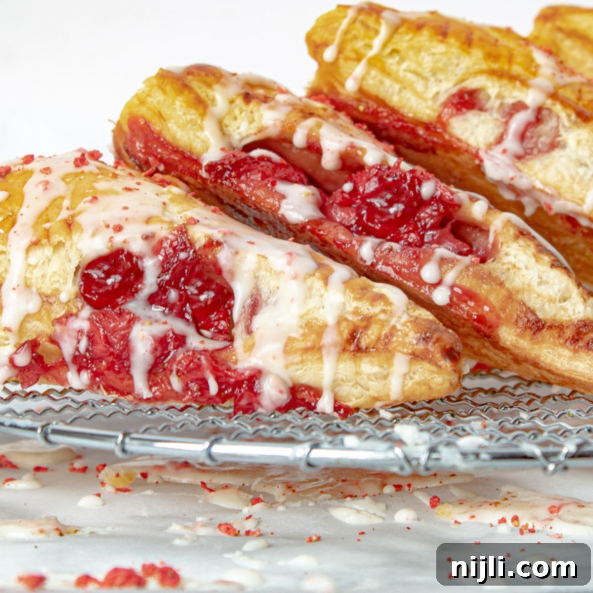 Sweet Strawberry Hand Pies 7 Iced strawberry turnovers on a rack