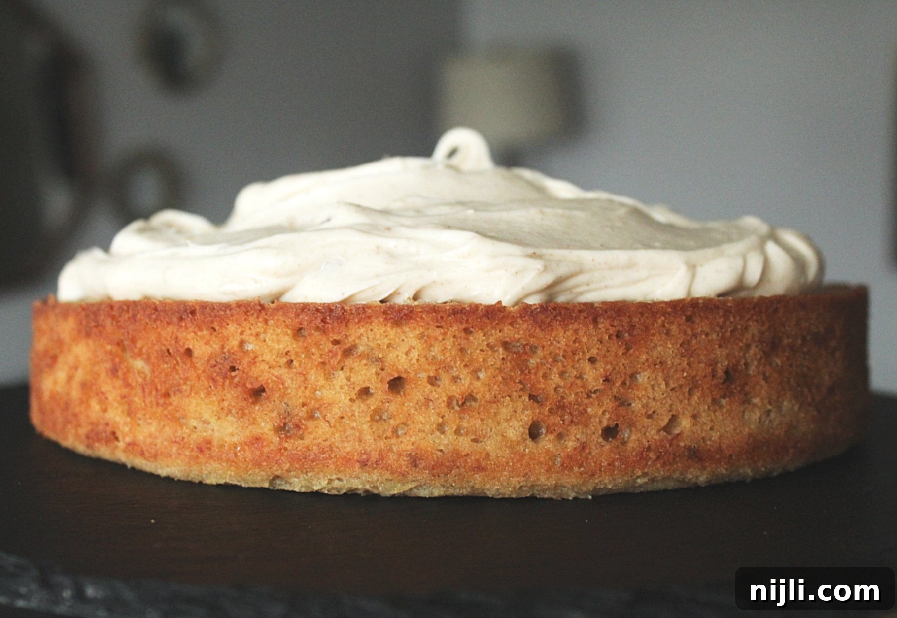 Banana Spice Cake with Toasted Butter Cream Cheese 4 Side closeup of spiced banana cake recipe topped with creamy brown butter cream cheese frosting.