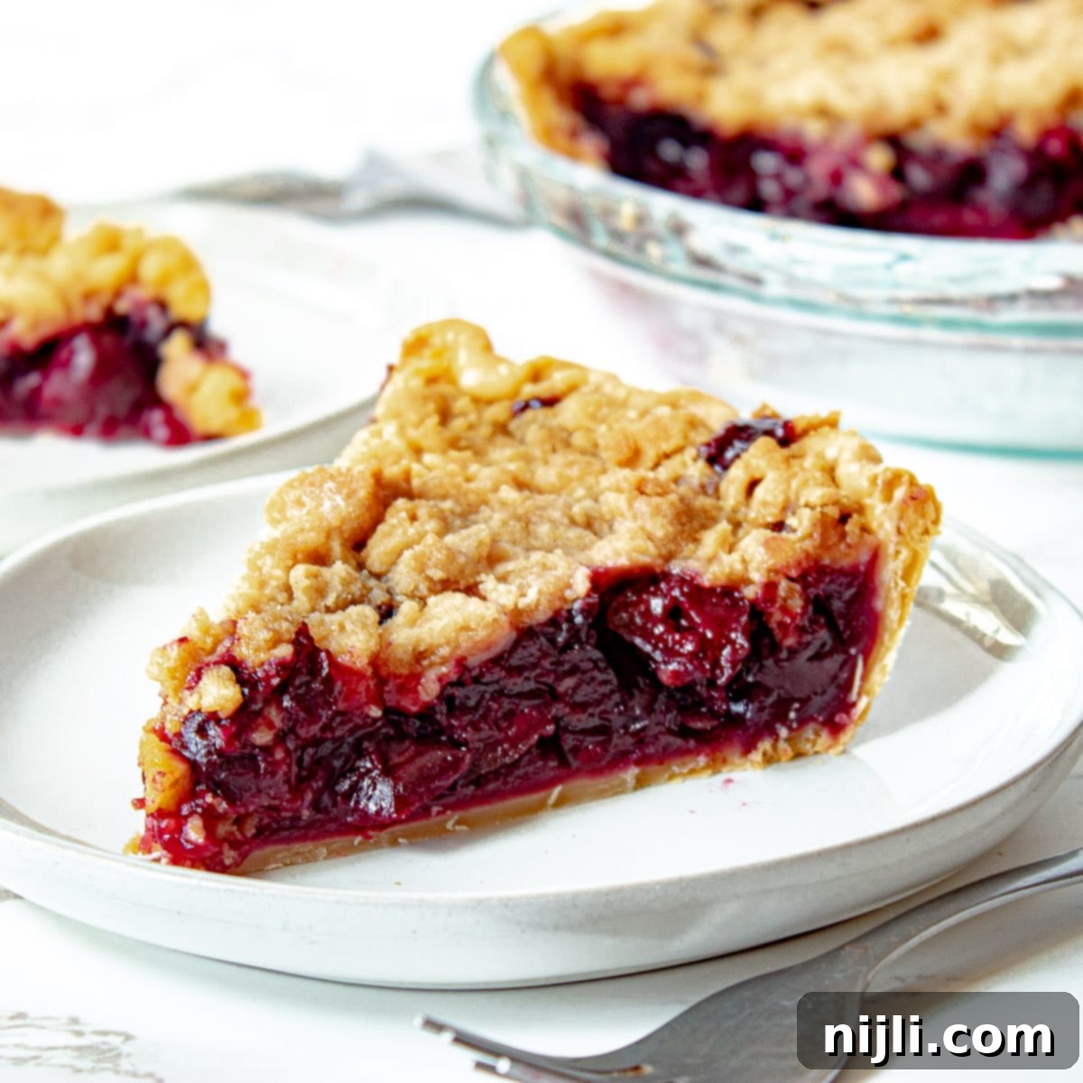 Homemade Cherry Crumb Pie 2 cherry crumb pie on a plate with a fork