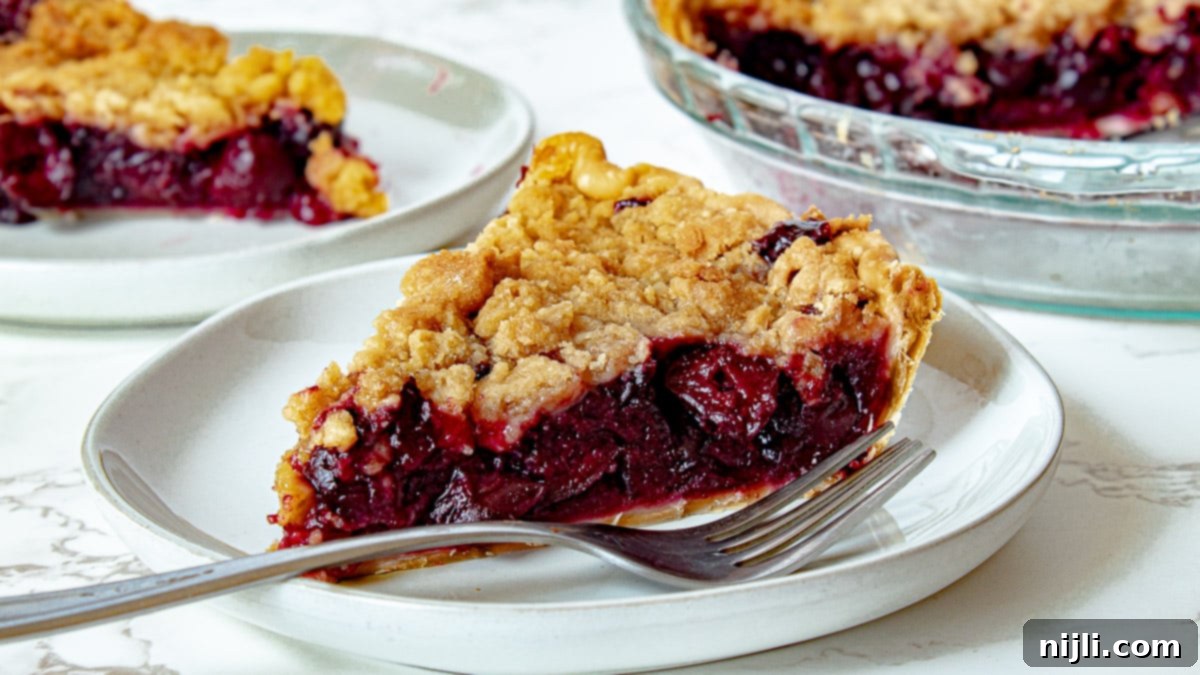 Homemade Cherry Crumb Pie 5 cherry crumb pie on a plate with a fork