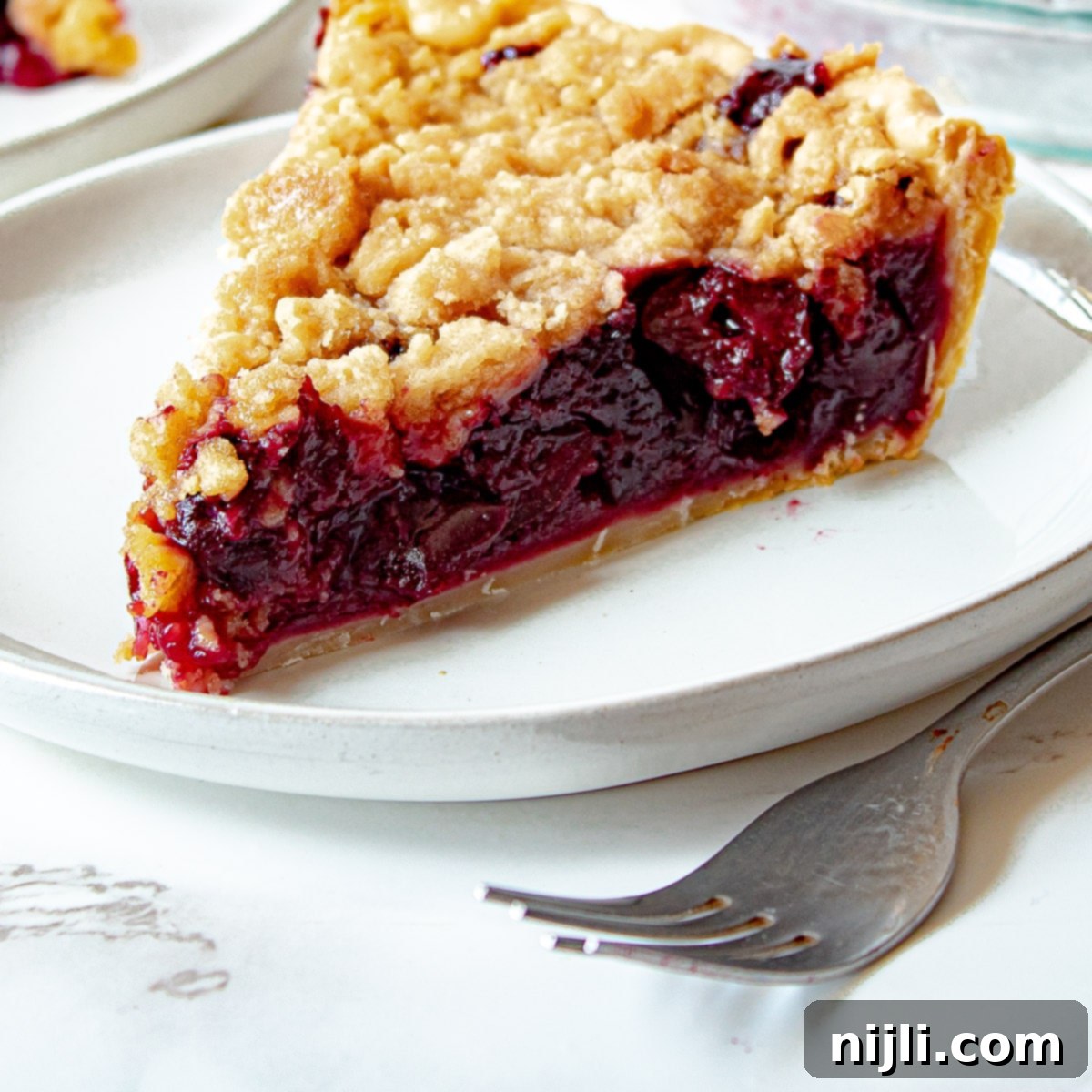 Homemade Cherry Crumb Pie 6 cherry crumb pie on a plate