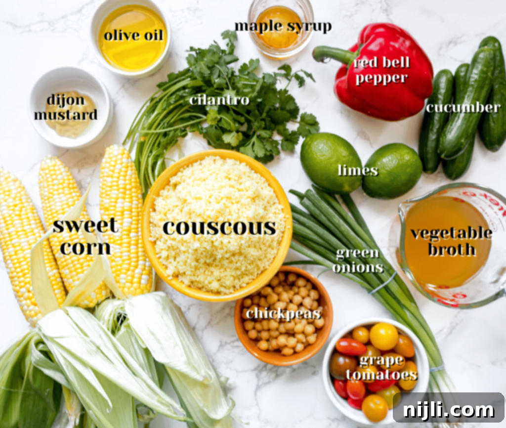 Vibrant Vegan Couscous & Chickpea Salad 4 A colorful array of fresh ingredients for vegan couscous salad laid out on a cutting board, including chickpeas, corn, bell pepper, and herbs.