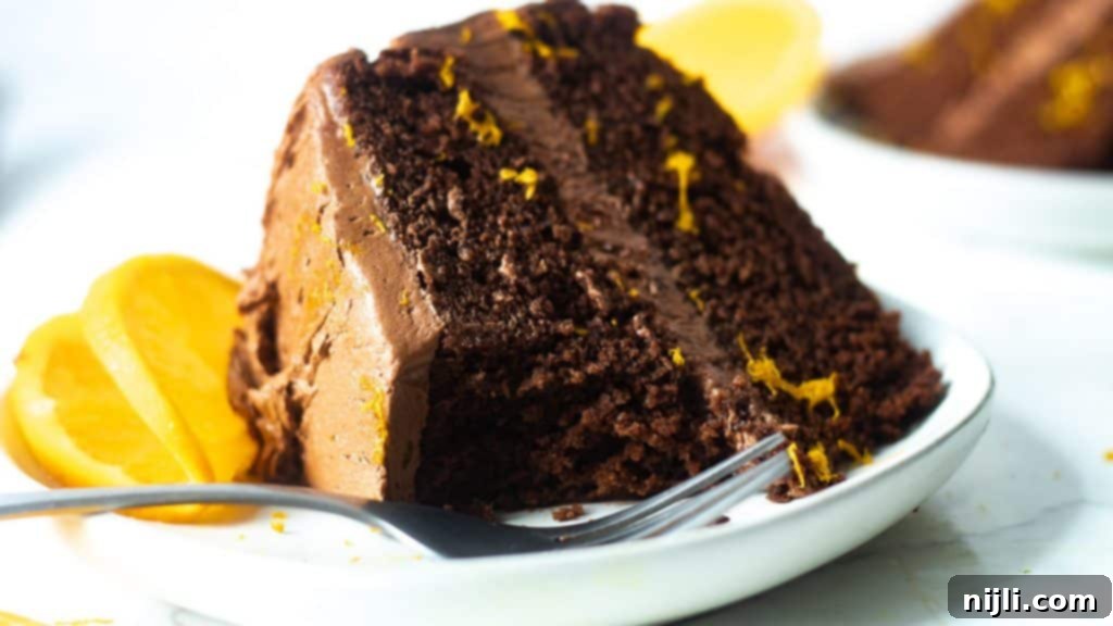 Zesty Chocolate Orange Sensation 6 dark chocolate orange cake with a piece cut out of it