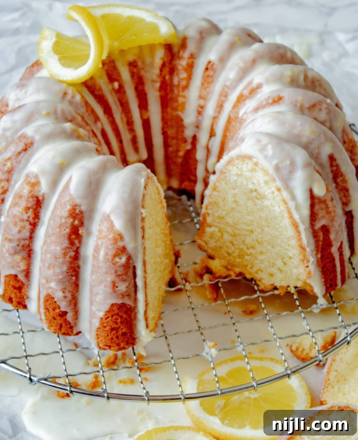 lemon sour cream pound cake on a wire rack with slices cut out and a southern living magazine next to it