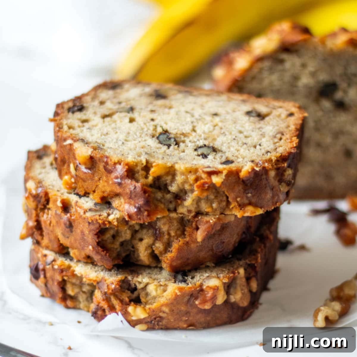 Plant-Based Banana Bliss 7 stack of dairy free banana bread next to the loaf