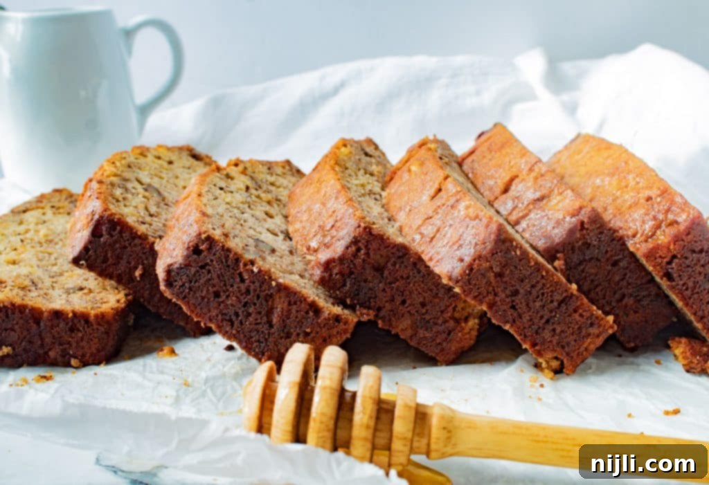 Tropical Pineapple Banana Bread 3 slices of pineapple banana bread with a honey dipper