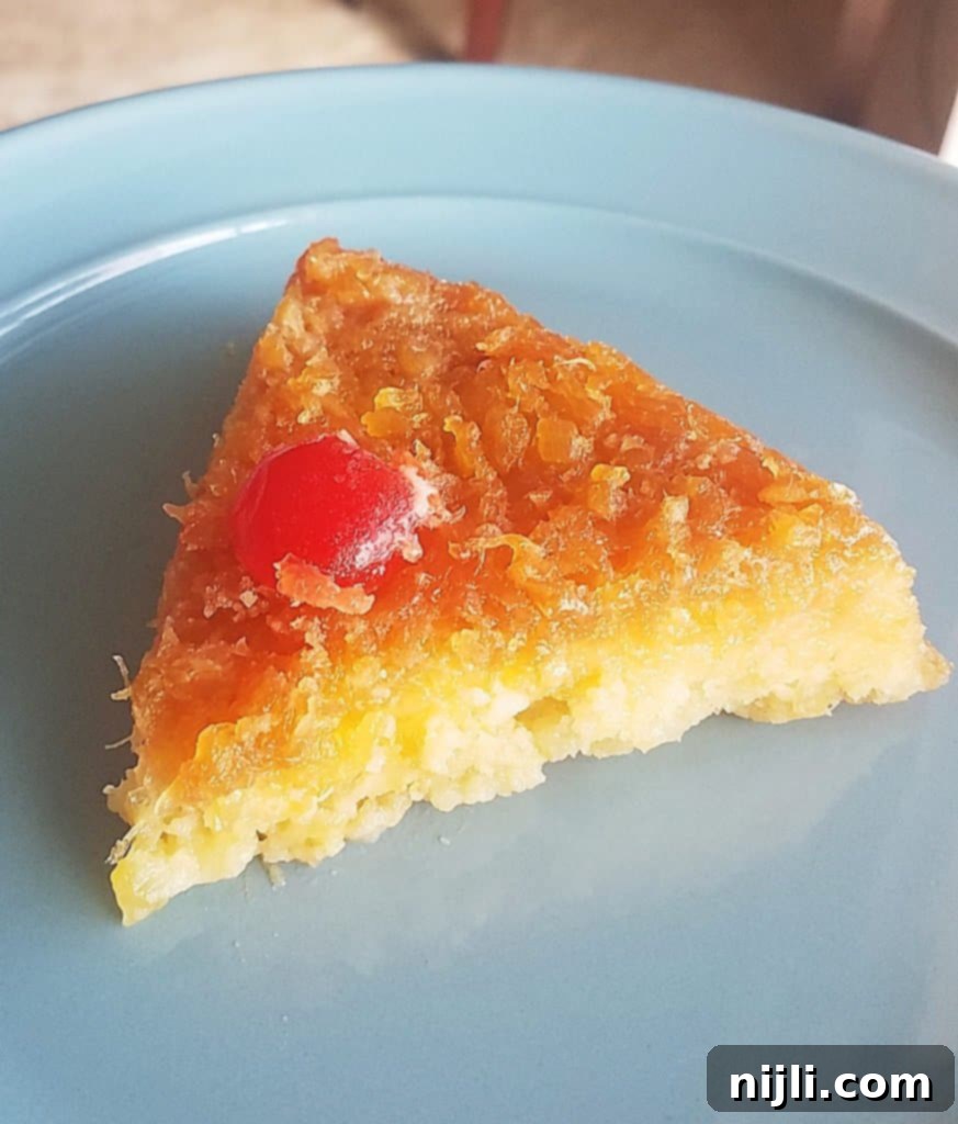 Sunny Skillet Pineapple Flip 3 Close-up of the delicious pineapple upside down cake with its beautiful caramelized topping and maraschino cherries.