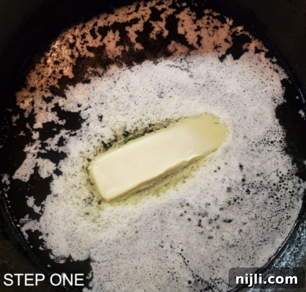 Sunny Skillet Pineapple Flip 4 Mixing cake batter in a large bowl, showing the smooth, light yellow consistency before adding to the pan.