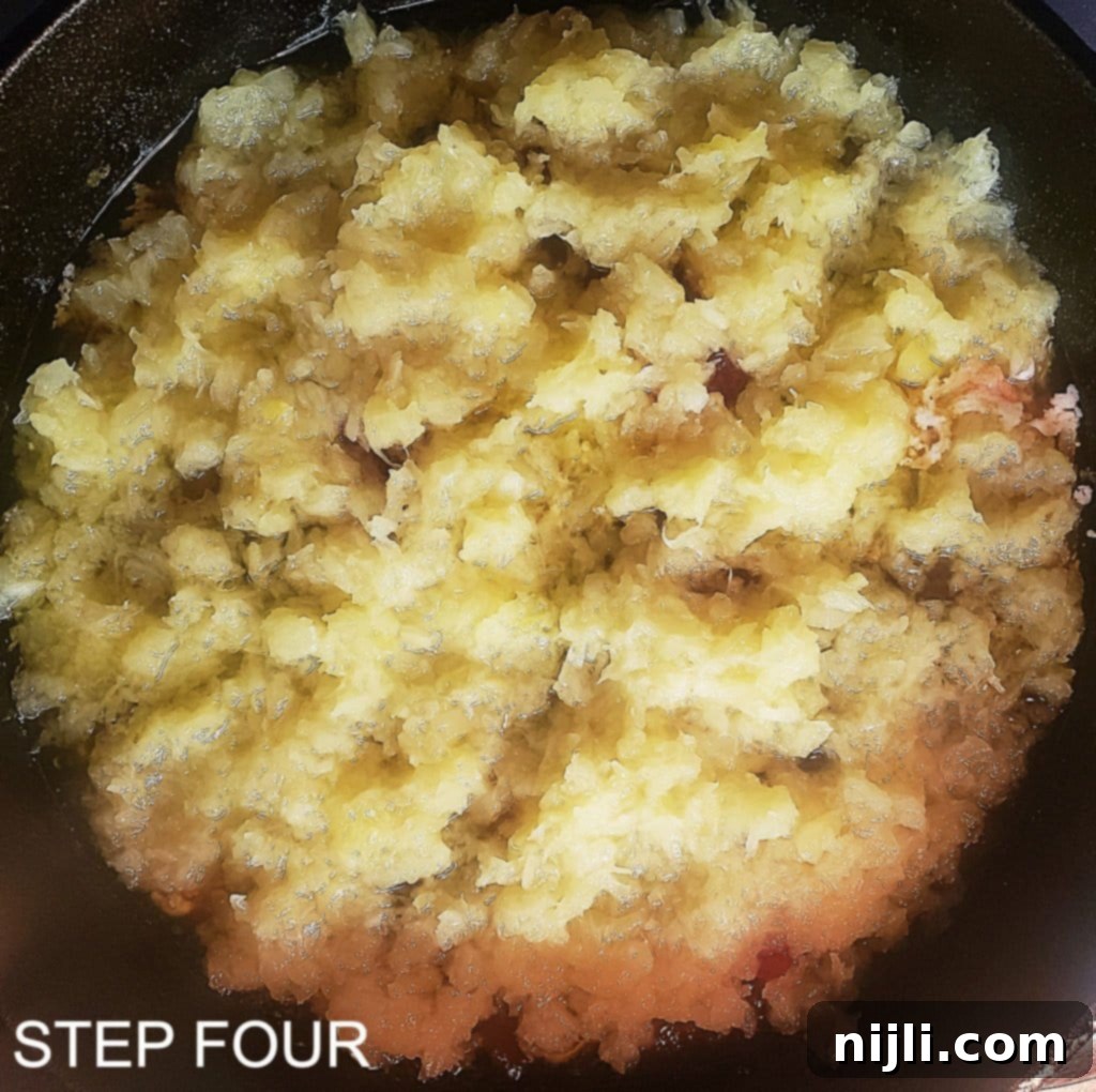 Sunny Skillet Pineapple Flip 7 Drained crushed pineapple gently spooned over the cherries and brown sugar in a cast iron skillet.