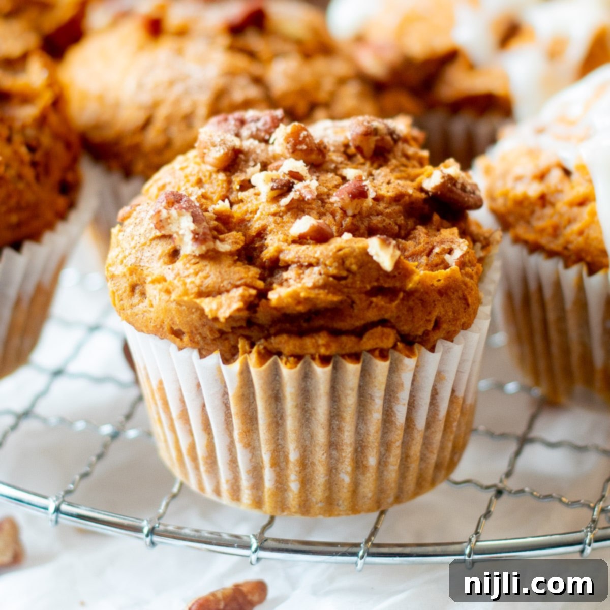 Effortless 3 Ingredient Pumpkin Muffins 7 close up of easy 3 ingredient pumpkin muffins on wire rack