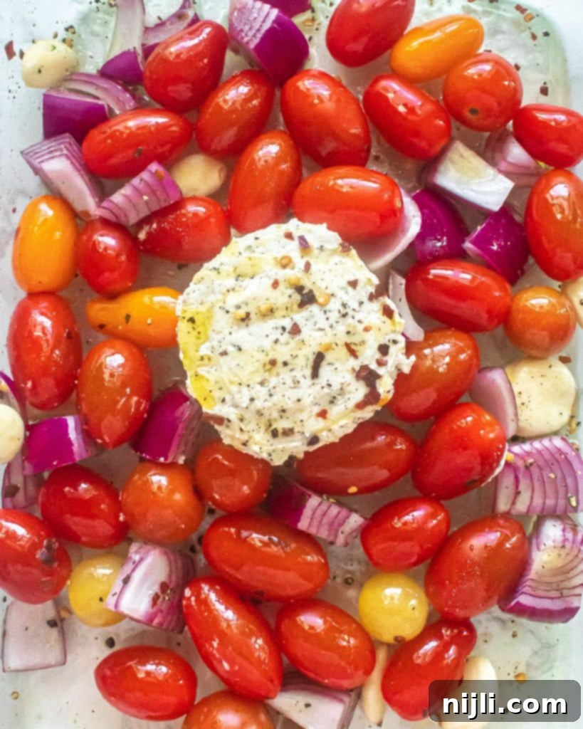 boursin cheese, tomatoes, onions, and garlic in a pan