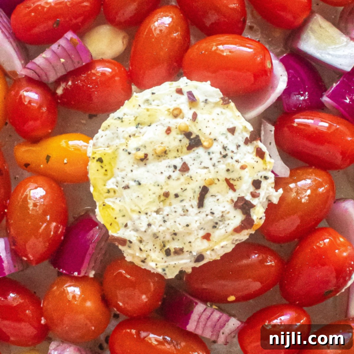 boursin cheese, tomatoes, onions, and garlic in a pan