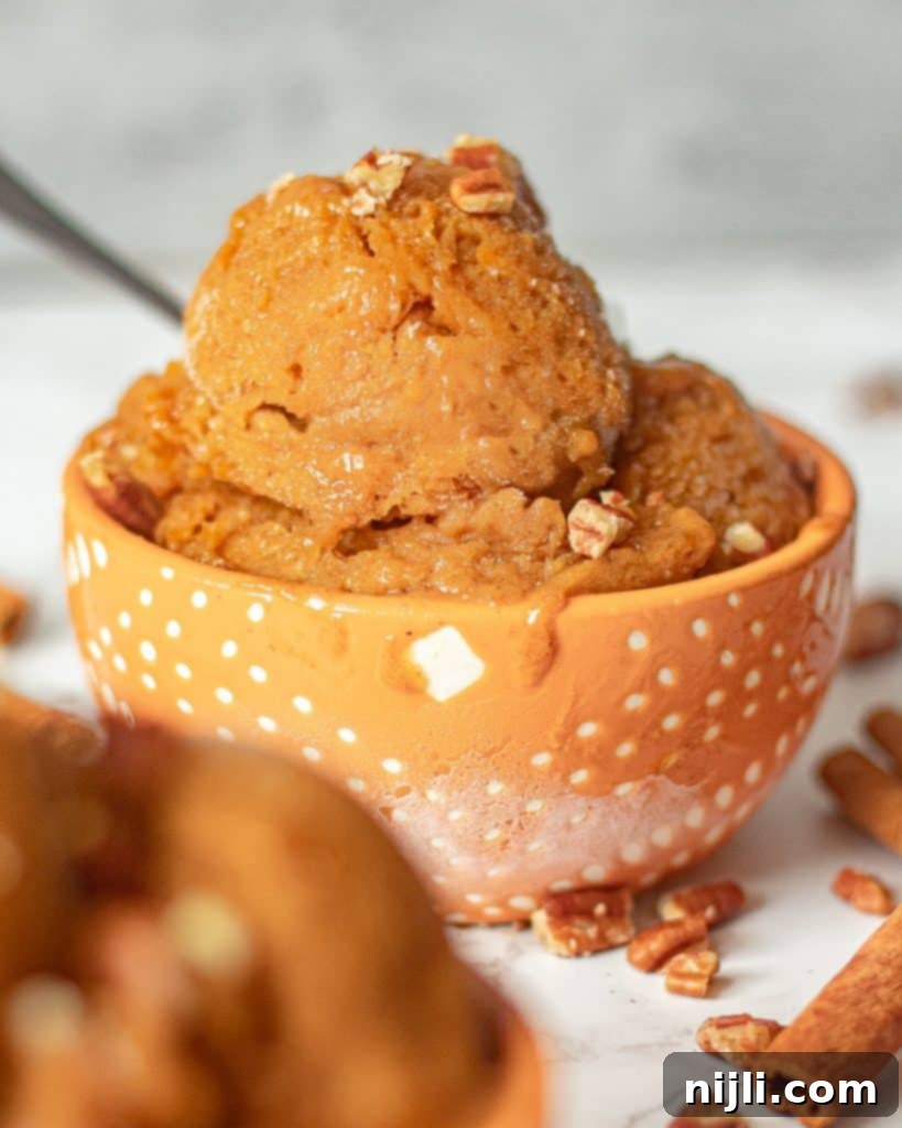 Wholesome Pumpkin Whip 3 Bowl of pumpkin nice cream topped with crunchy pecans, ready to be enjoyed.