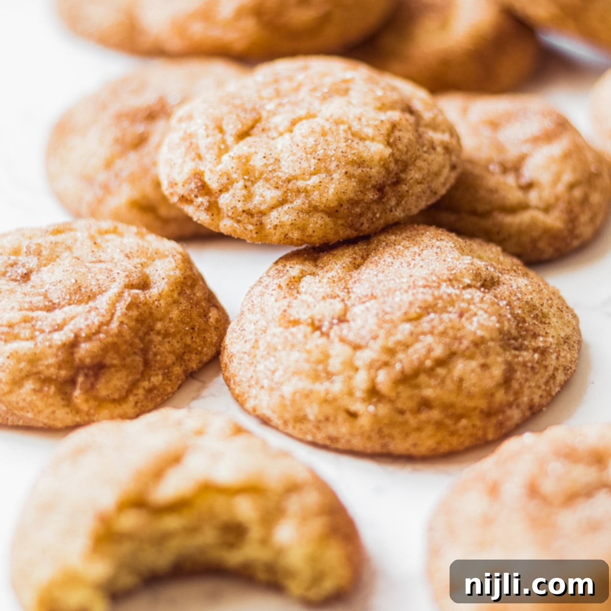 Snickerdoodles scattered on a tray