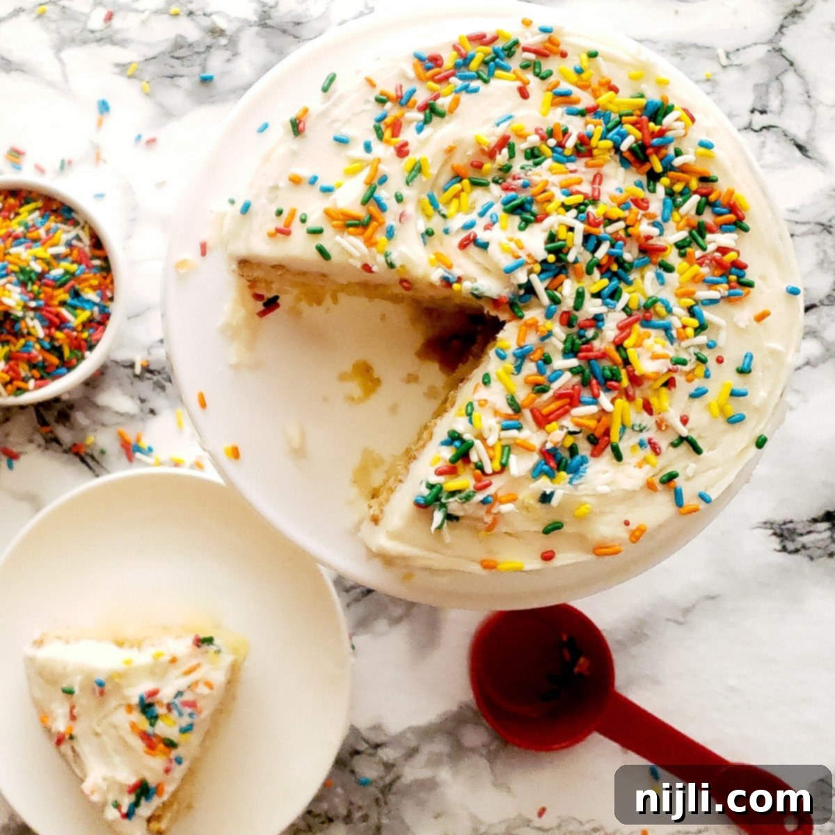 Easy Mini Vanilla Cakes Vanilla Buttercream 6 Mini vanilla cake recipe from above with frosting and sprinkles, a perfect small treat.