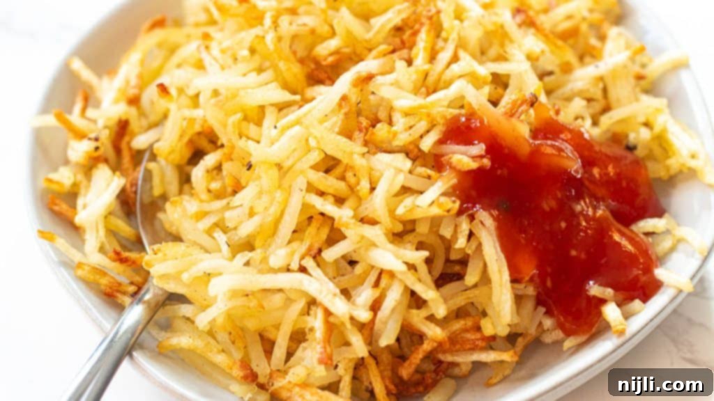 Crispy Air Fryer Hash Browns 5 closeup of hash browns in air fryer