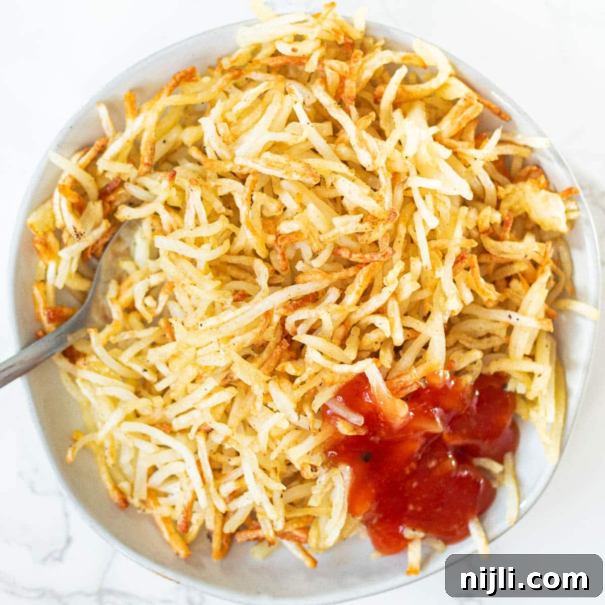 Crispy Air Fryer Hash Browns 7 overhead view of air fryer hash browns