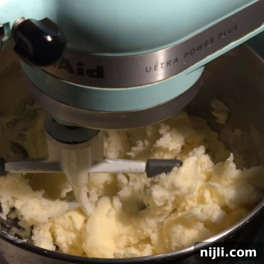 Creaming butter and sugar together until light and fluffy for the eggnog pound cake base.