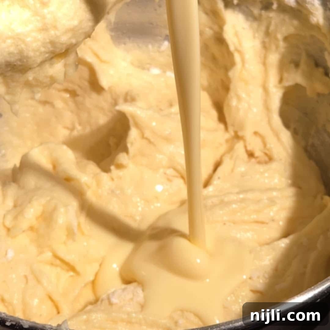 Alternating between adding dry ingredients and room temperature eggnog to the batter.